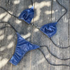 Blue bikini set on a wooden surface