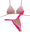 Pink polka dot bikini set with matching pink straps on a decorative wooden stand.