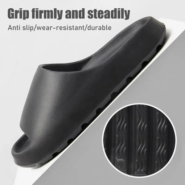 Black slipper with textured sole on a gray background, featuring text about grip and durability.