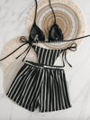 Black and white striped bikini set on a textured surface