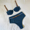 Blue denim-style bra and panties set with brown straps and buckles on a white background