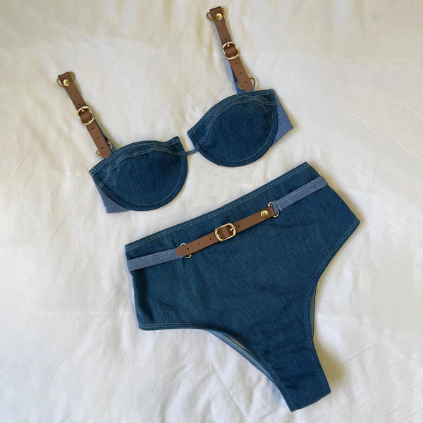 Blue denim-style bra and panties set with brown straps and buckles on a white background