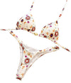 Floral bikini set on a decorative wooden surface with a visible brand tag.