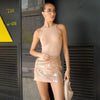Woman wearing a sheer top and sequin skirt on a white background