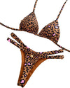 Leopard print bikini set with a brand tag on a decorative wooden surface