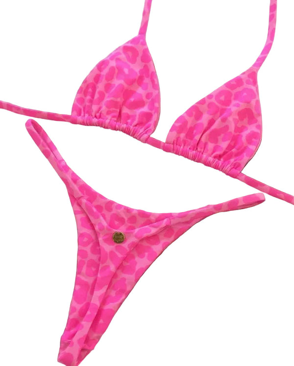 Pink bikini set with a pattern on a decorative brown mat