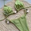 Green bikini set on a woven mat