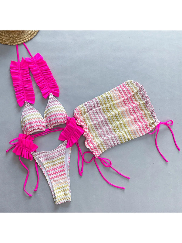 Colorful bikini set with pink straps on a gray background