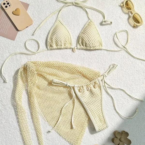 Beige bikini set with matching sarong on a light background