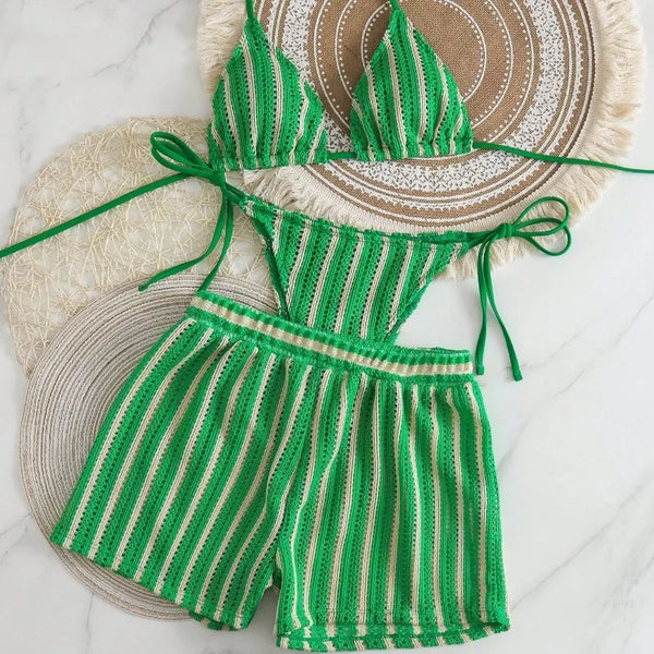 Green and beige striped crochet outfit with a matching hat on a white background