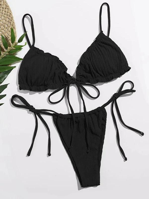 Black bikini set with tied straps on a white background