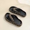 Pair of leopard print slippers on a light background