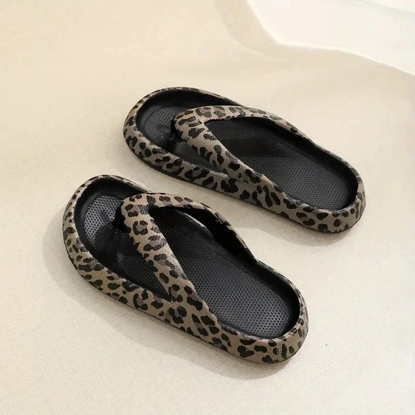 Pair of leopard print slippers on a light background