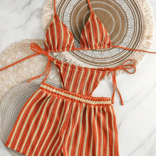 Striped crochet romper on a textured surface