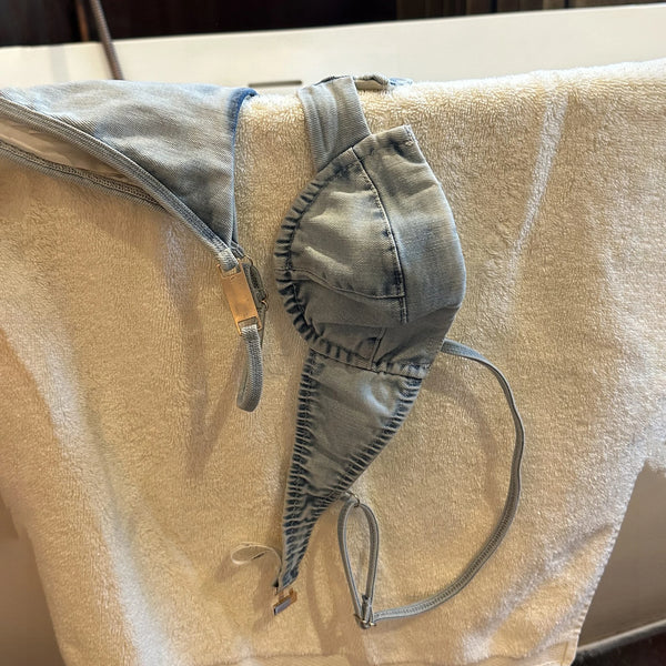 Denim thong on a beige towel with a blurred background