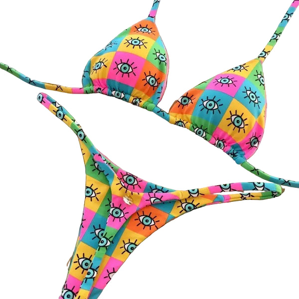 Colorful bikini set with checkered pattern on a decorative wooden surface