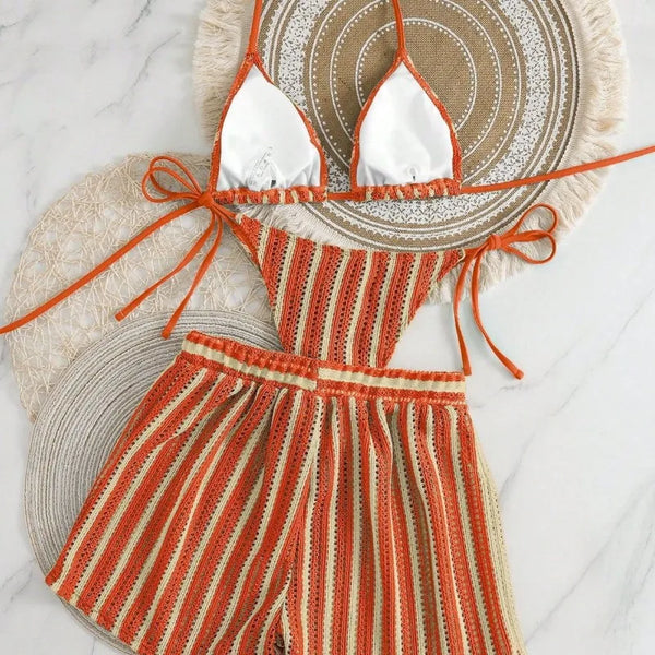 Orange and white striped outfit with matching hat on a light background