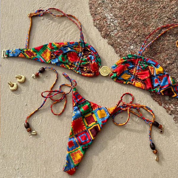 Colorful bikini set with matching accessories on a textured surface