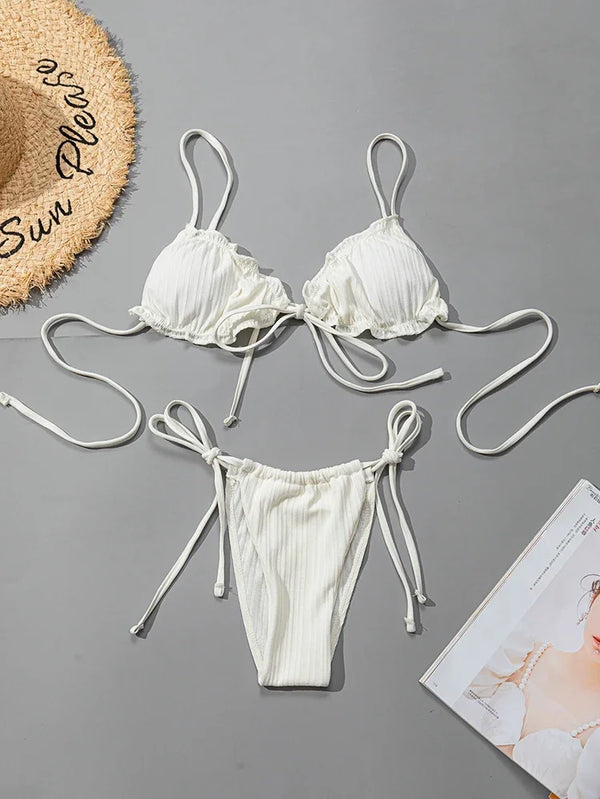 White bikini set with matching straps on a gray background
