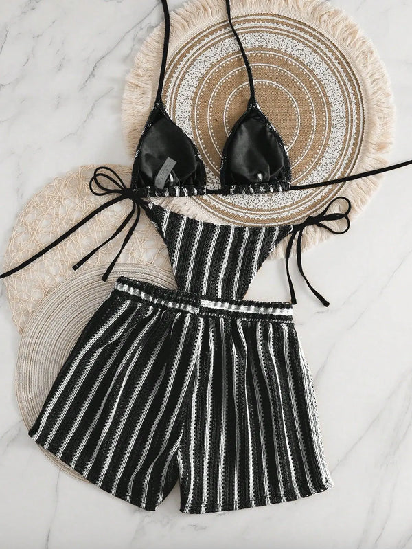 Black and white striped bikini set on a textured surface